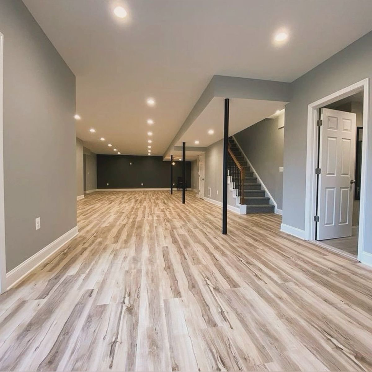Finished basement with wide-plank flooring, pot lights and open stairwell in a Vaughan home